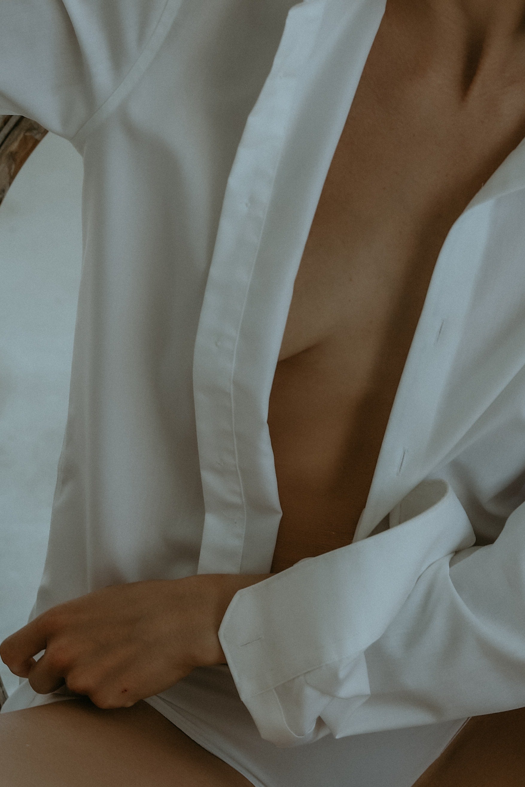 Woman with a white overzised shirt.